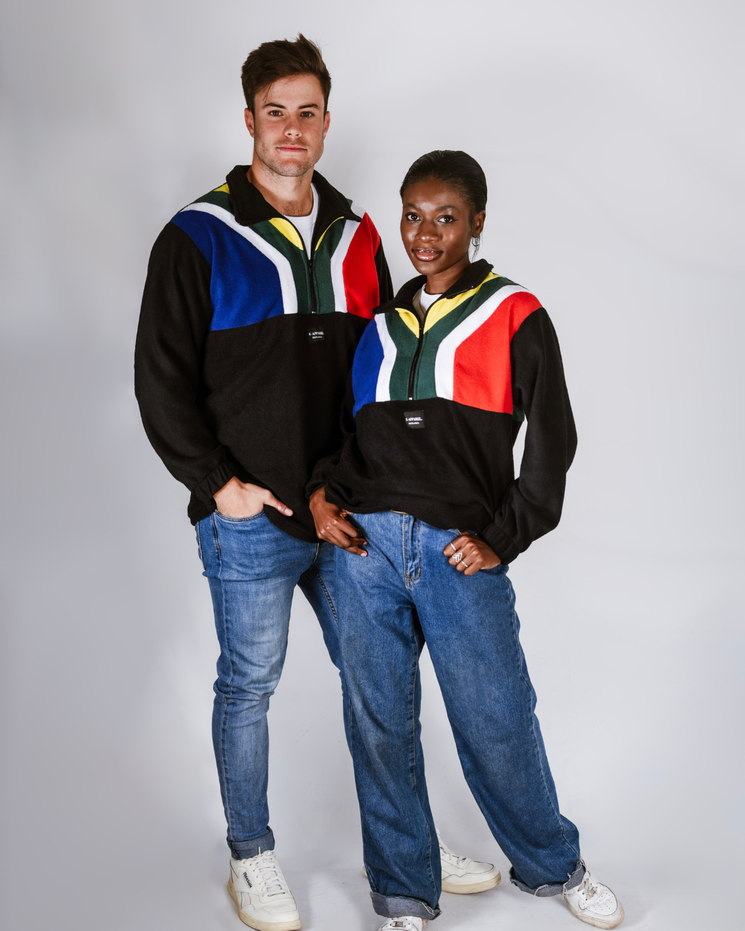 Male and female wearing a black south african flag supporters jersey.