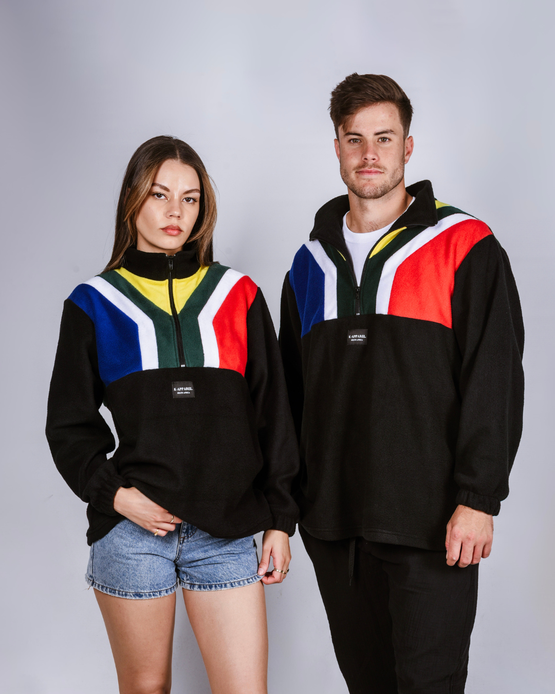 Male and female wearing a black south african flag supporters jersey.