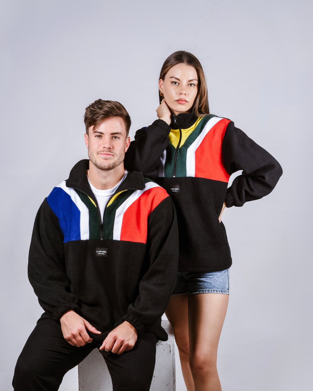 Male and female wearing a black south african flag supporters jersey.