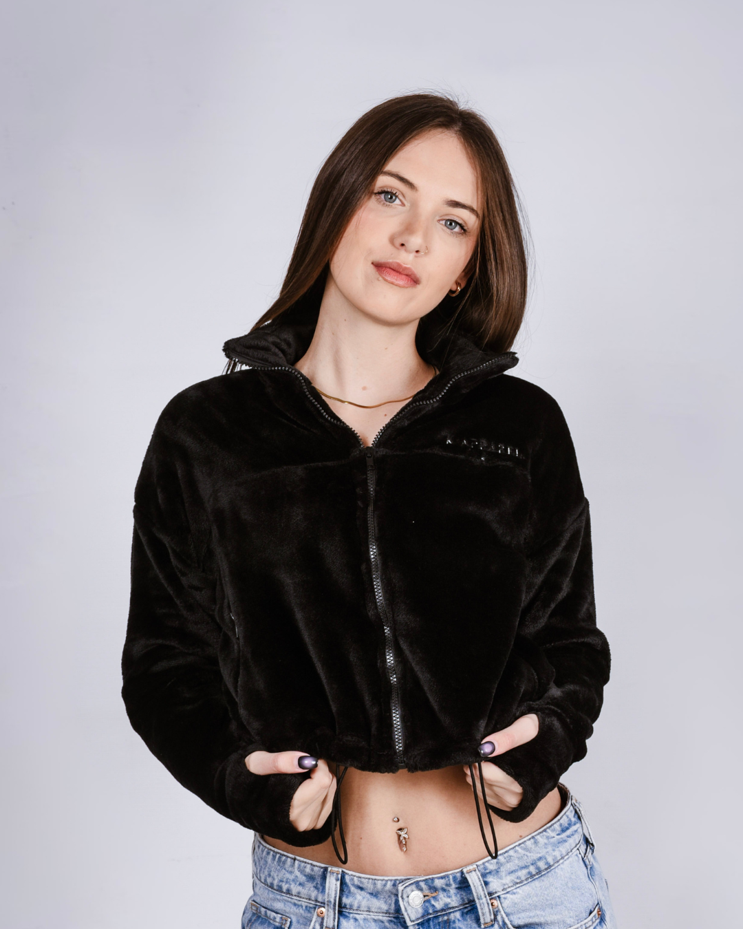 woman wearing a black fluffy jacket with draw cords and thumb holes