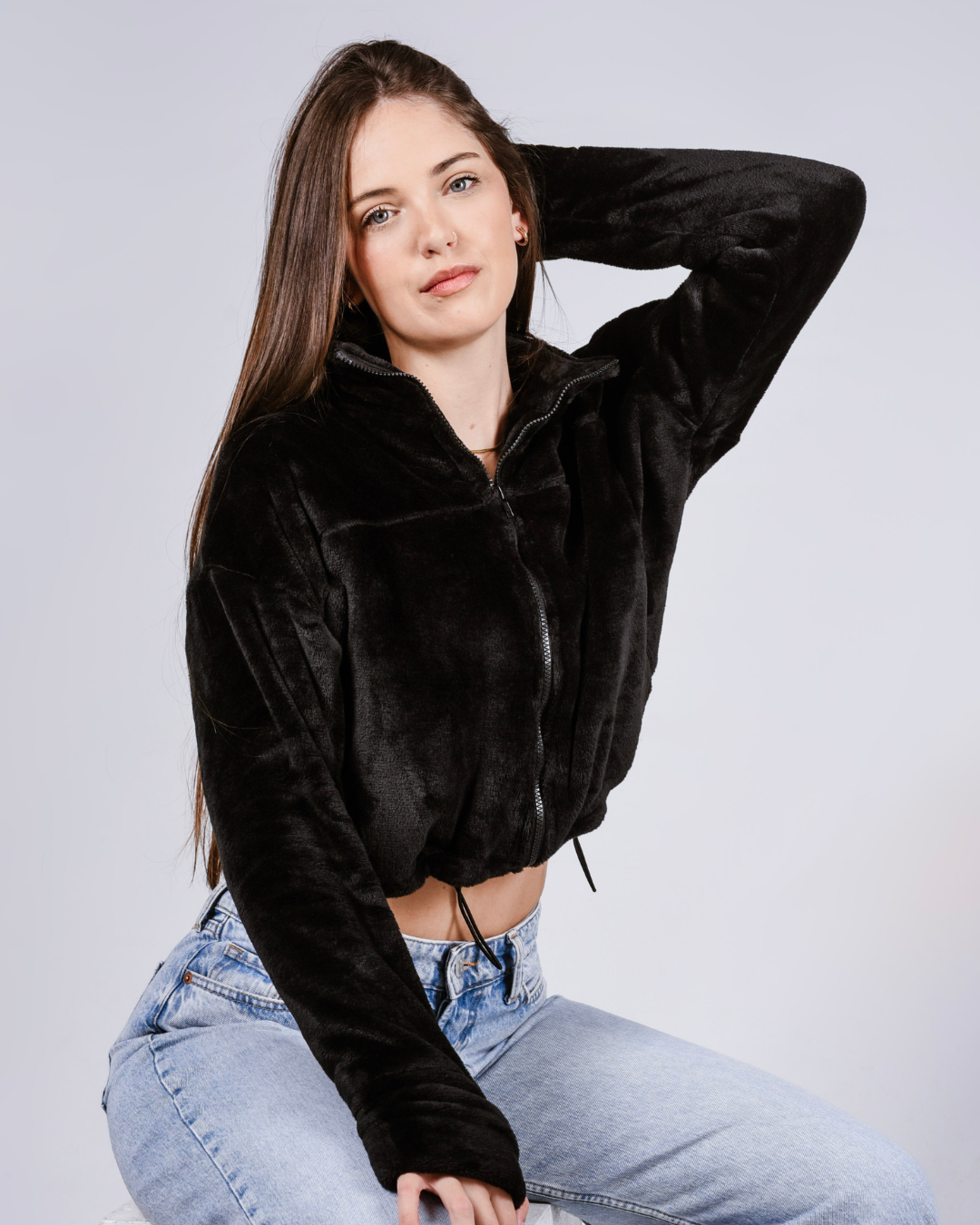 woman wearing a black fluffy jacket with draw cords and thumb holes