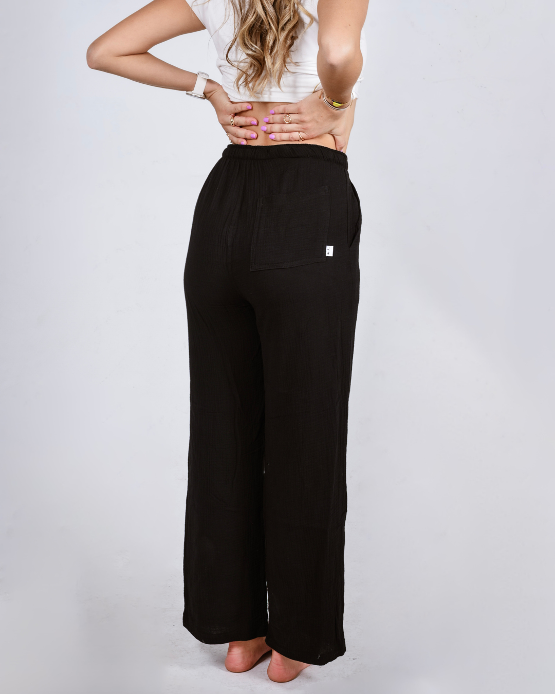 Female wearing black cotton high waisted pants