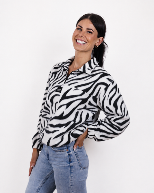 Female wearing the Zebra quarter zip jersey in studio
