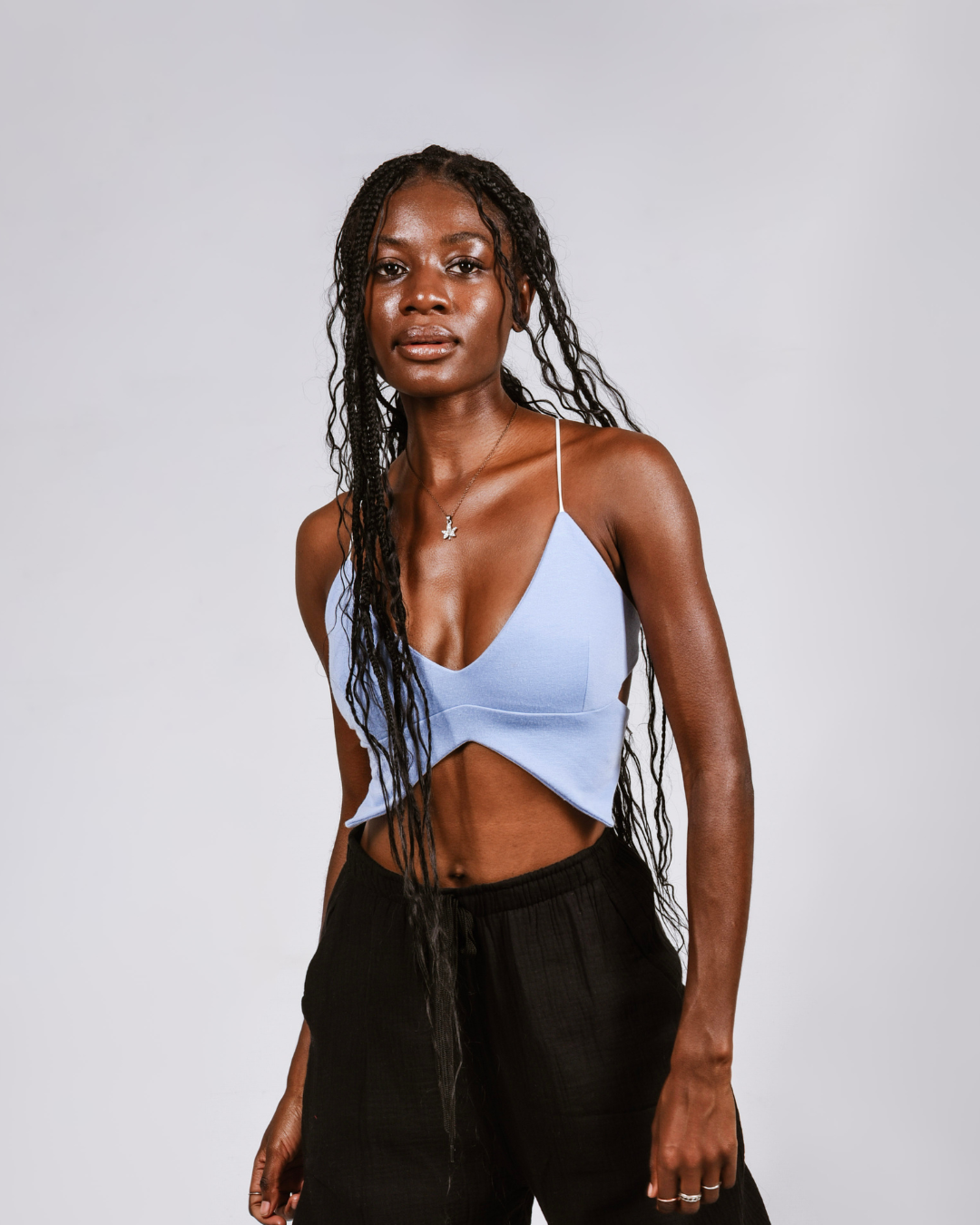 Woman wearing a blue butterfly shaped top that ties at the back
