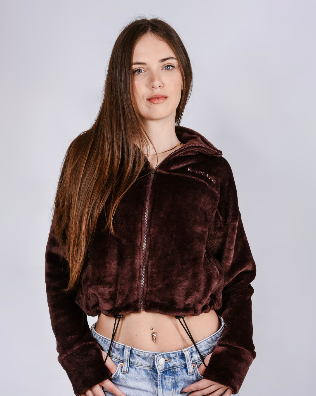 woman wearing a brown fluffy jacket with draw cords and thumb holes