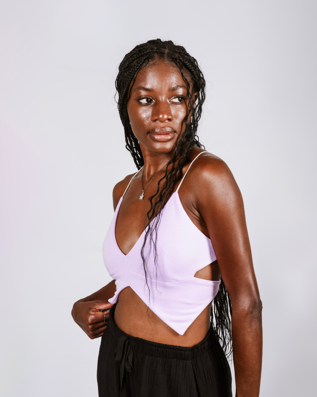 Woman wearing a purple butterfly shaped top that ties at the back