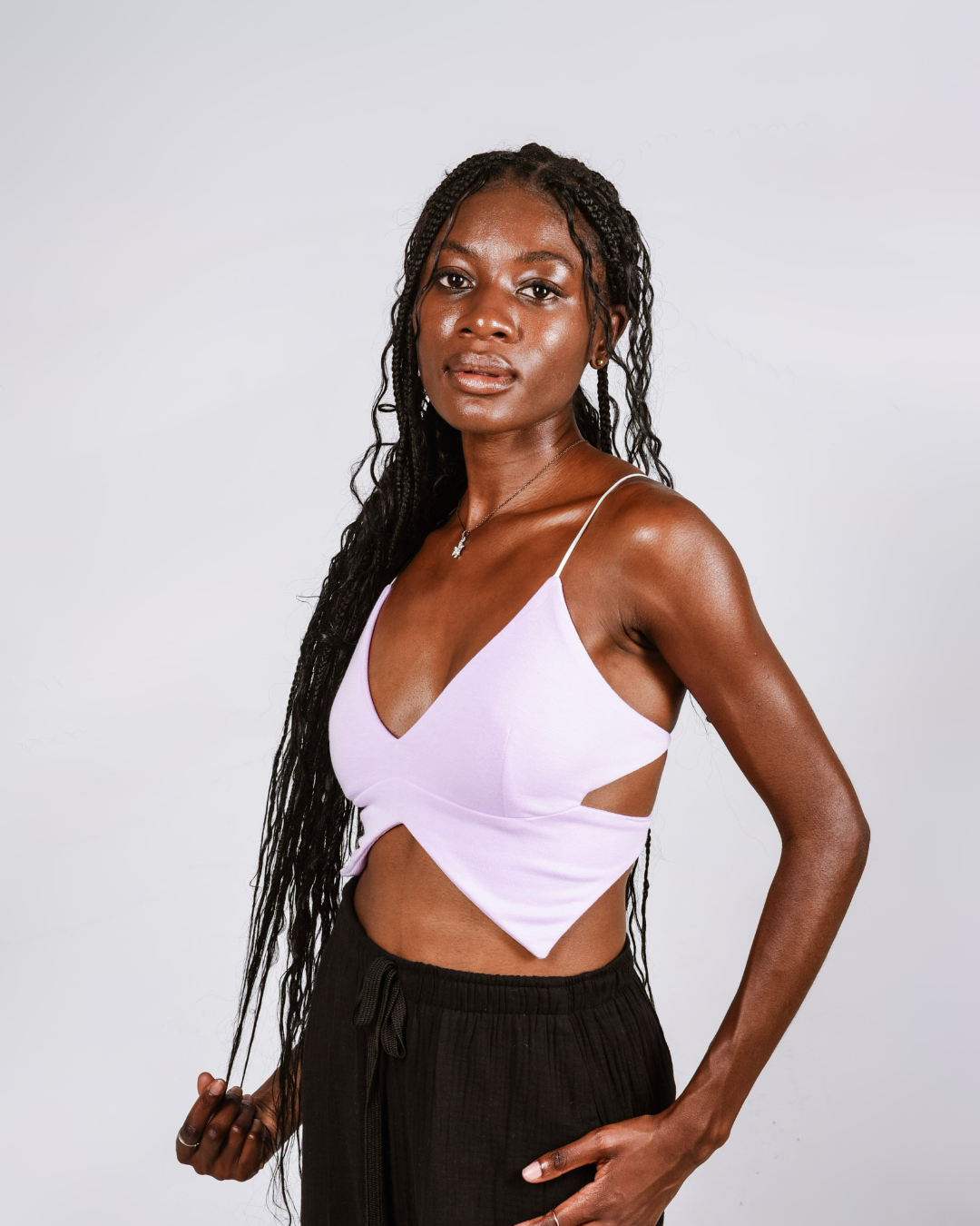Woman wearing a purple butterfly shaped top that ties at the back