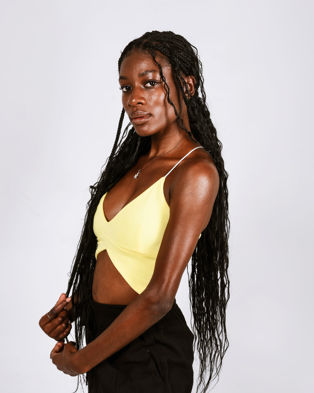 Woman wearing a yellow butterfly shaped top that ties at the back