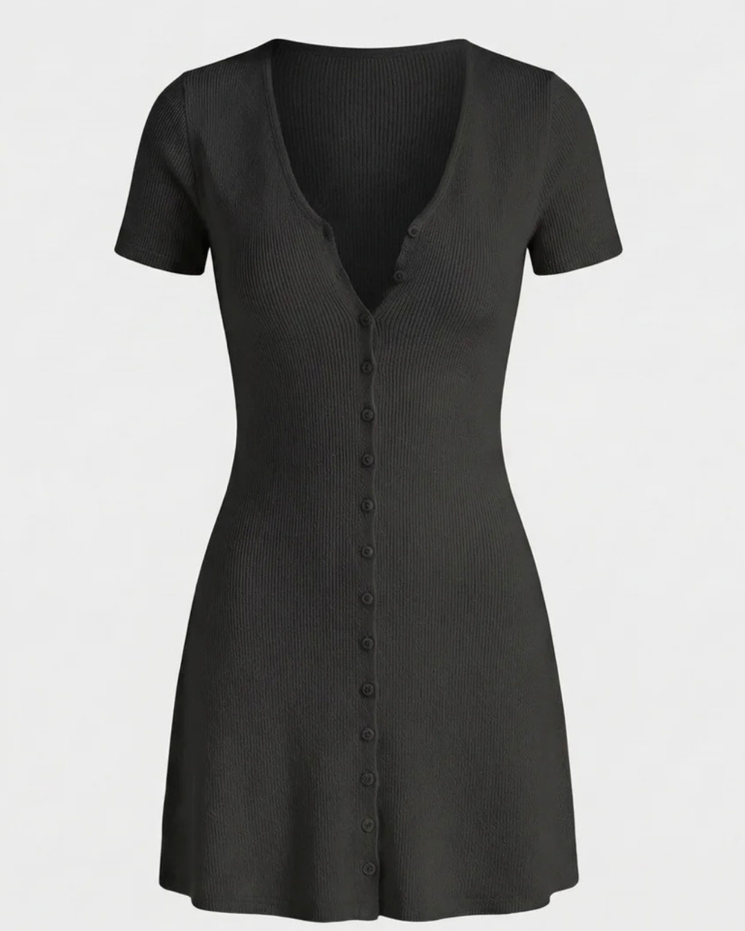 Woman wearing a black button up knit dress against a plain background