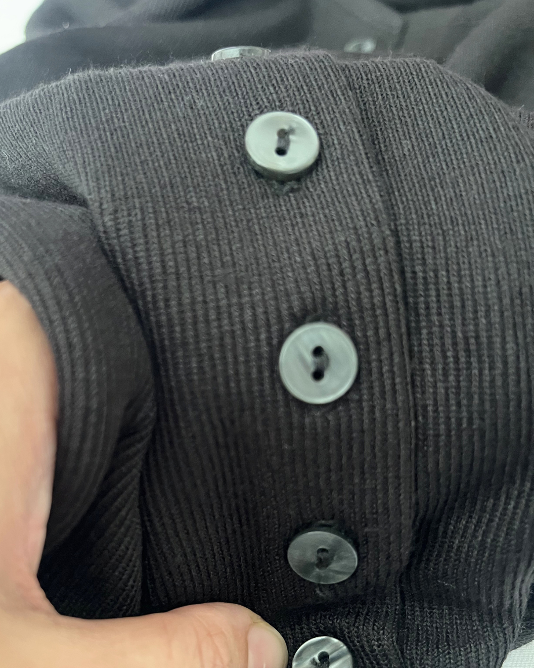 Close up of black button up knit dress 