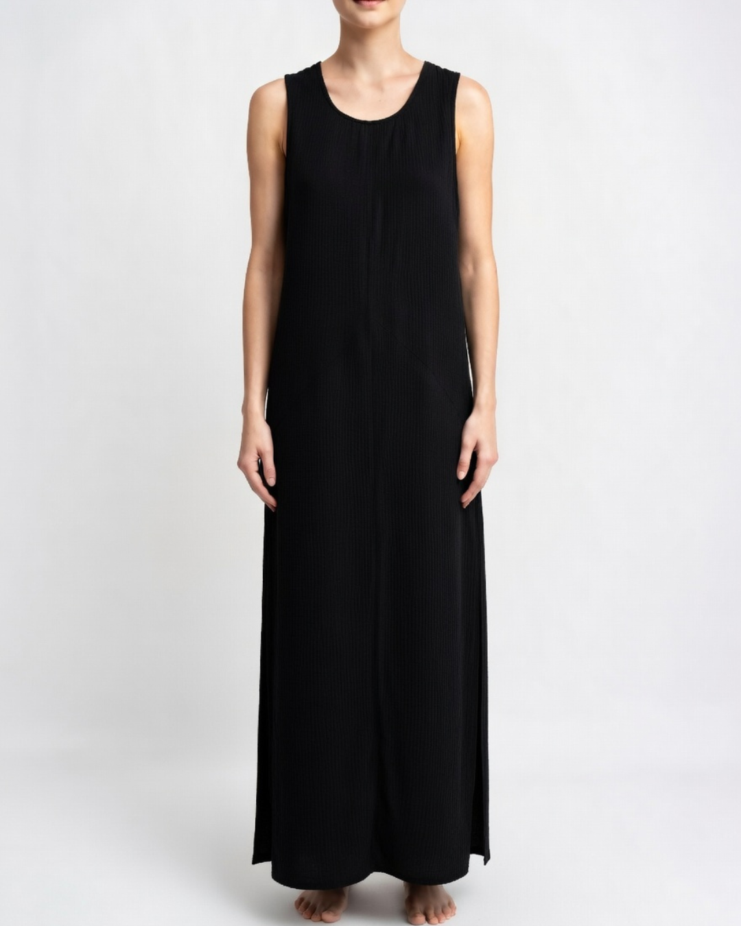Female wearing a long black cotton maxi dress in studio 