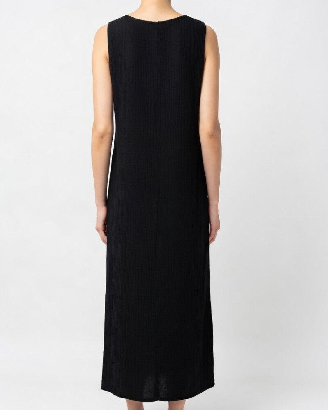 Female wearing a black coton maxi dress - back view 