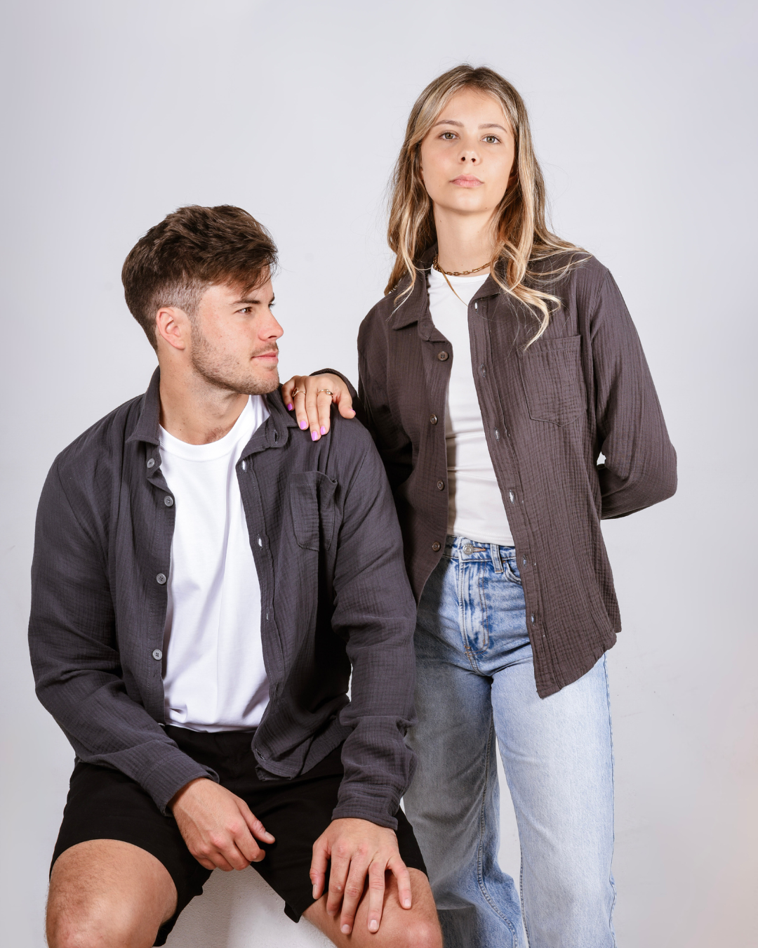 Male and female wearing the grey Button up cotton shirts.
