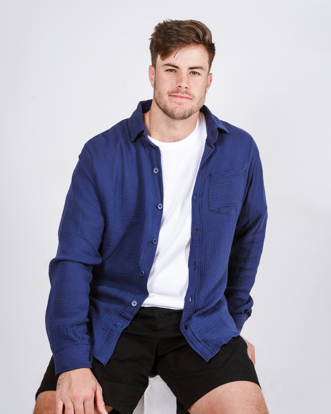 Male wearing a Button up cotton shirt in the colour navy