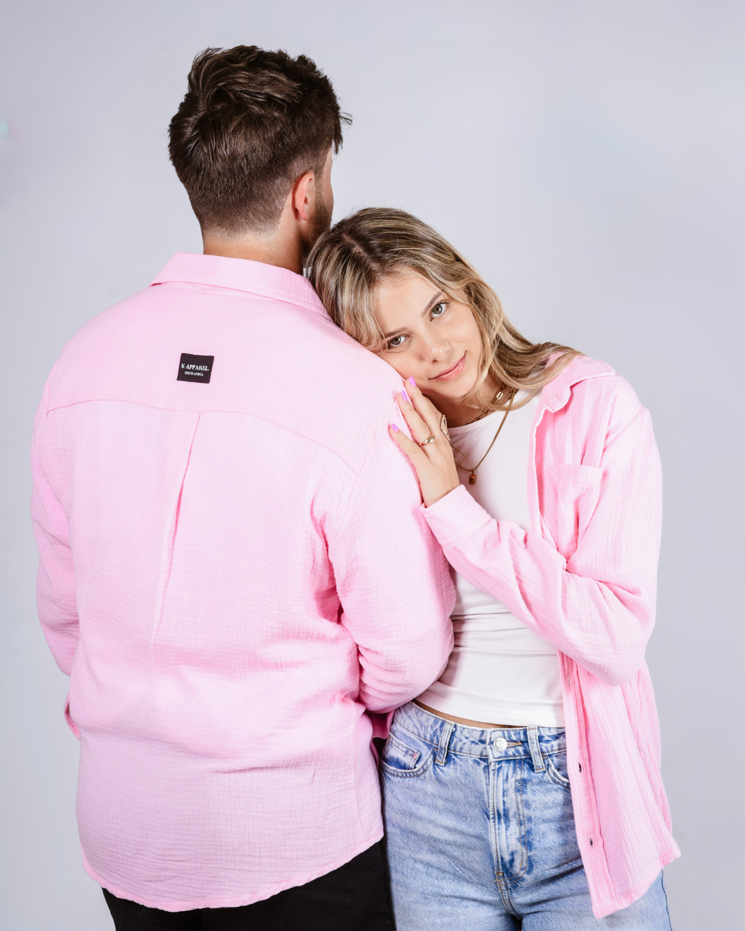 Male and female wearing the Button up cotton shirts in the colour pink