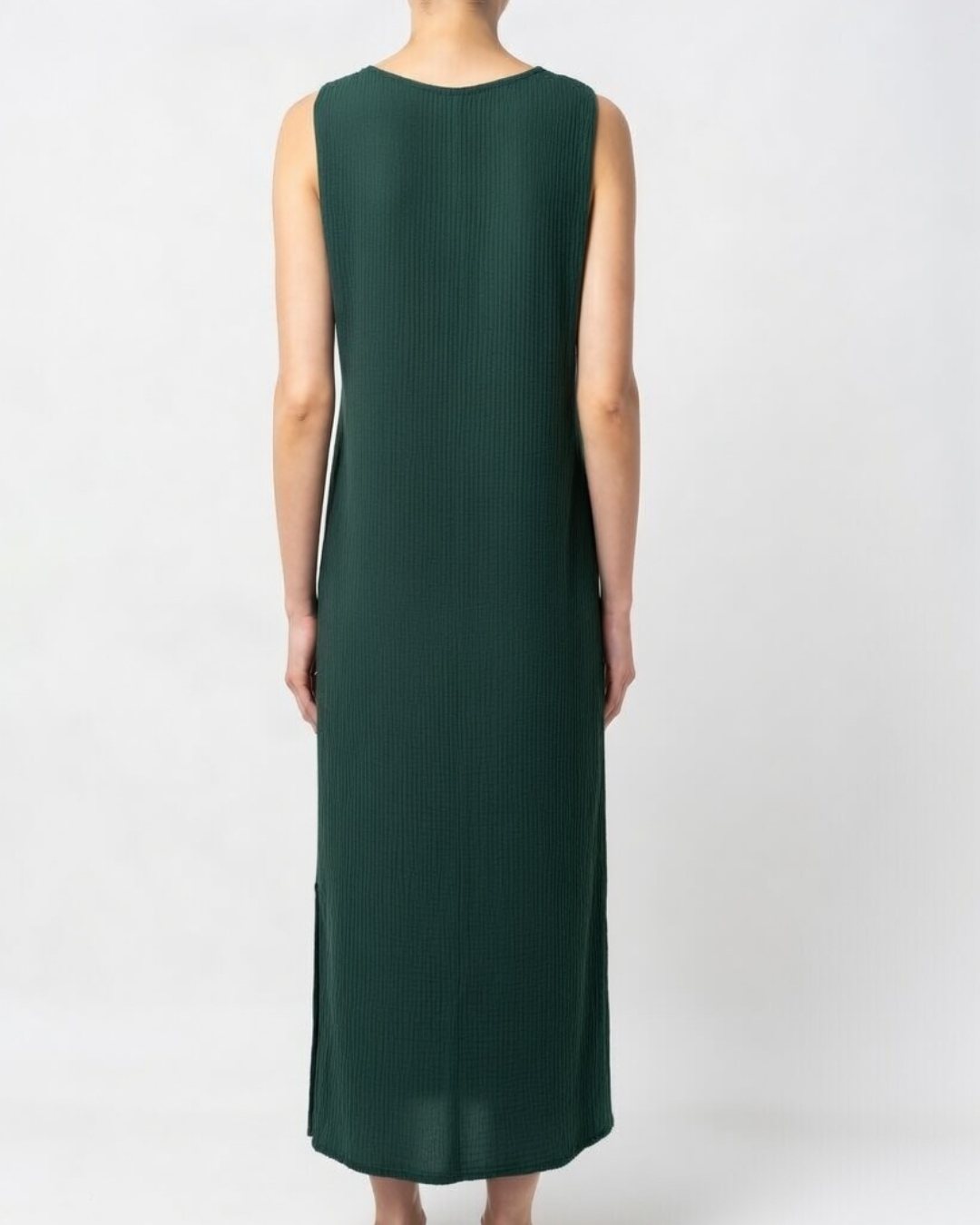 Female wearing a sleeveless emerald cotton maxi dress 