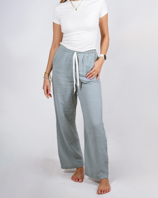 Female wearing cotton high waisted pants in colout teal