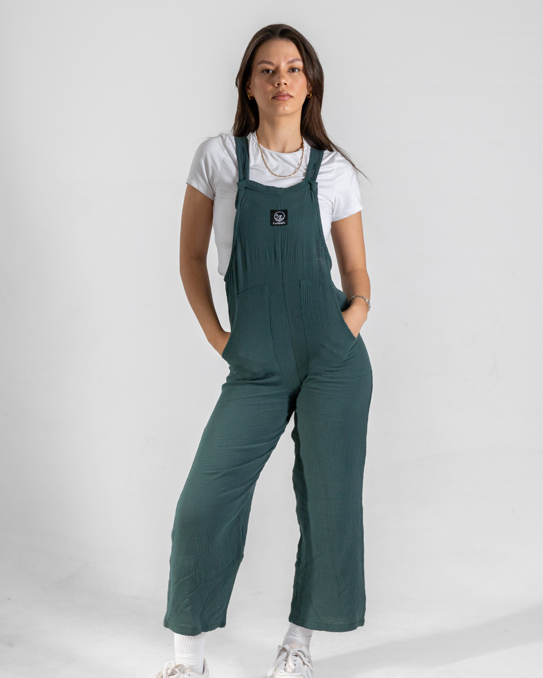 Female wearing a green cotton dungaree in a studio