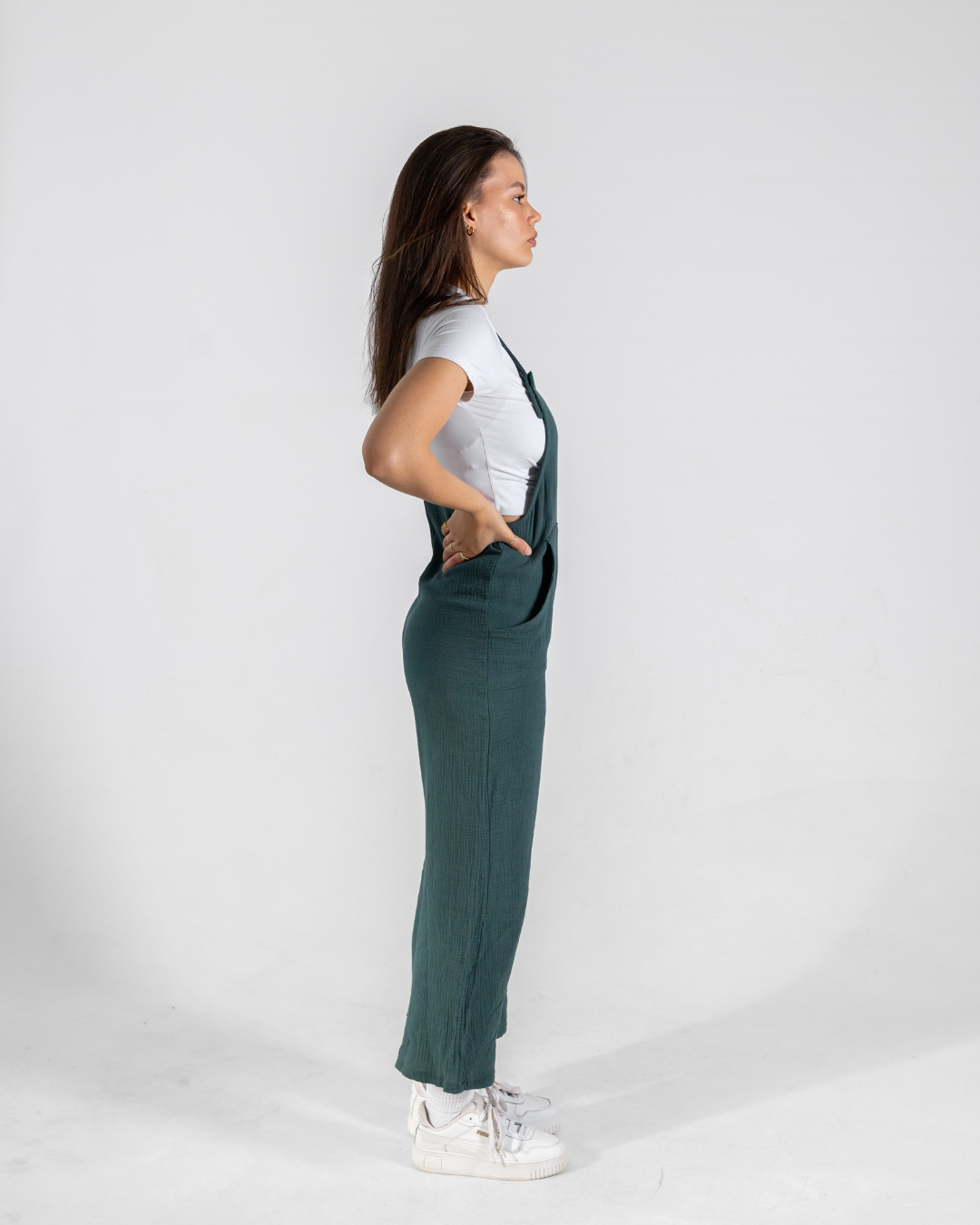 Side view of a female wearing her dungarees 
