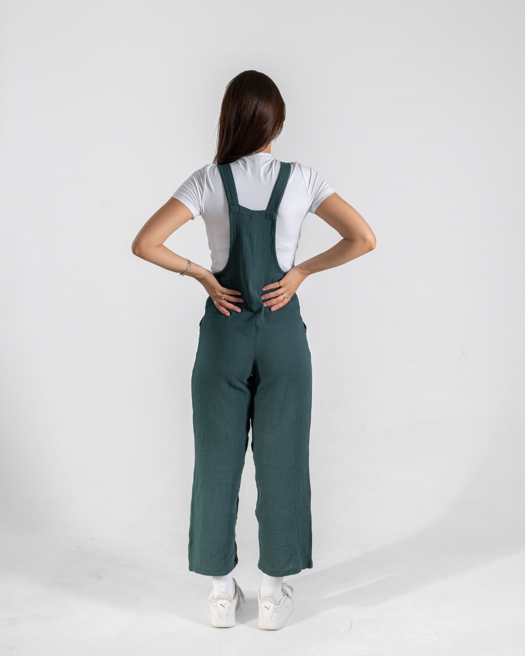 Back view of female wearing her green dungarees 