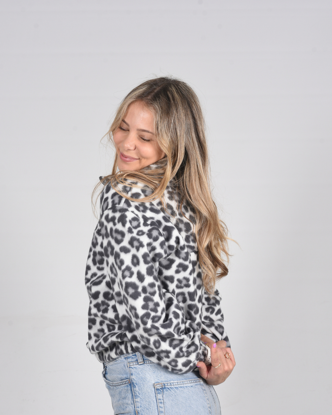 Side view of a female wearing a leopard print jersey