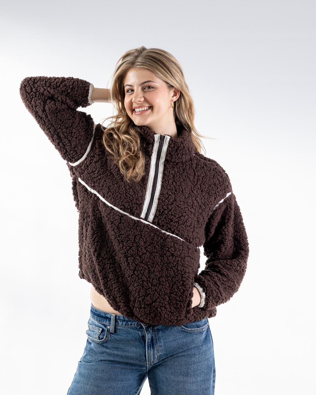 Female wearing a mocca lama fleece in studio 