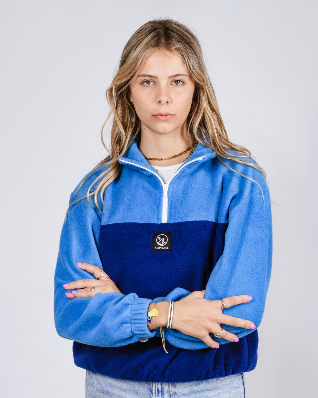 Female wearing an OG quarter zip retro jersey in blue and navy 