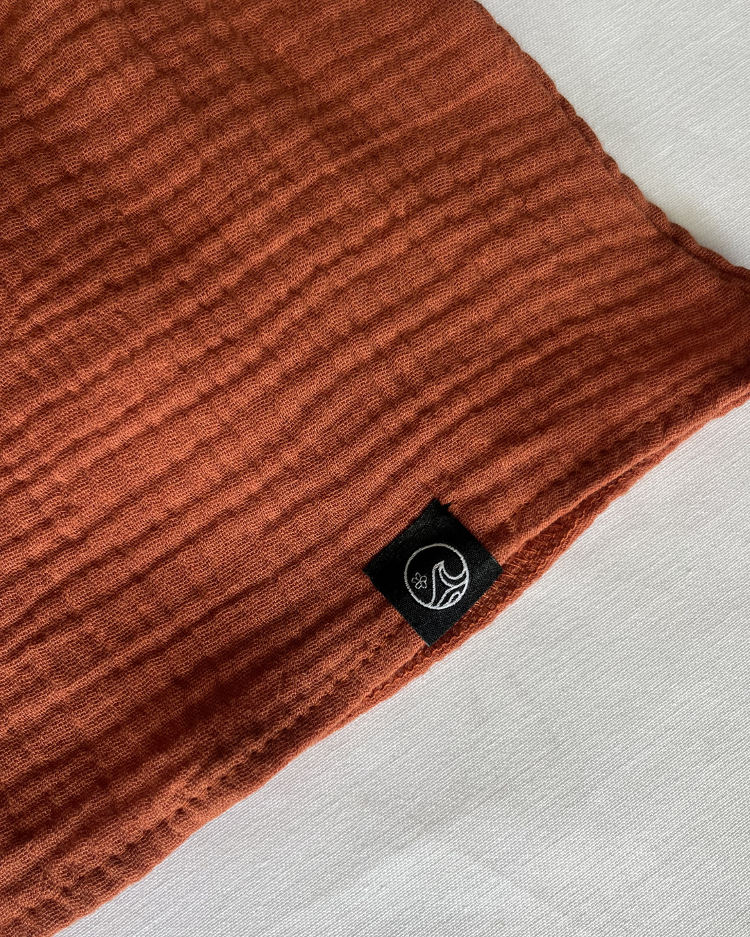 Close up of the orange maxi dress bottom patch 