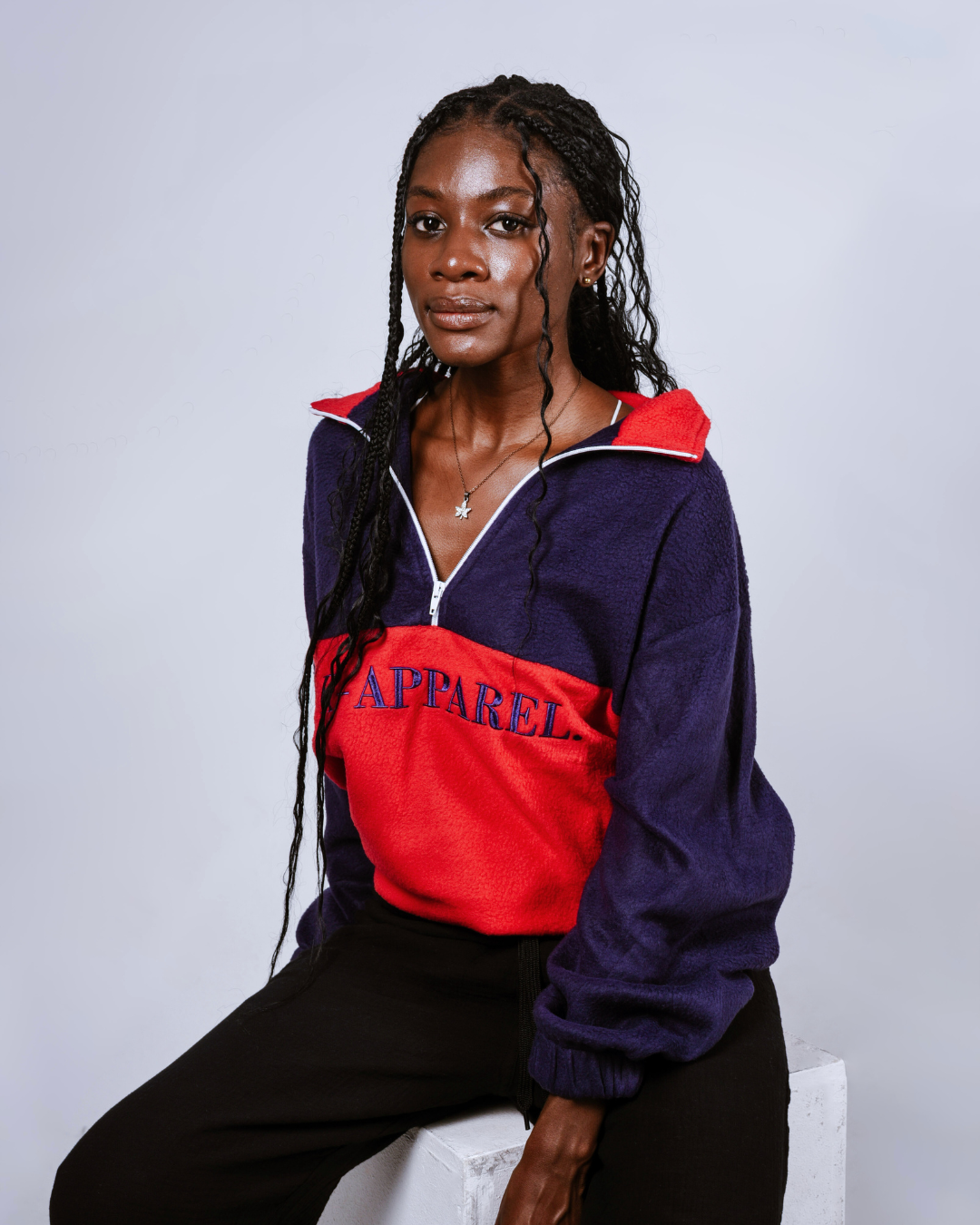 Two people wearing matching red and navy blue retro quarter zip jersey with 'Kapparel' branding on a white background.