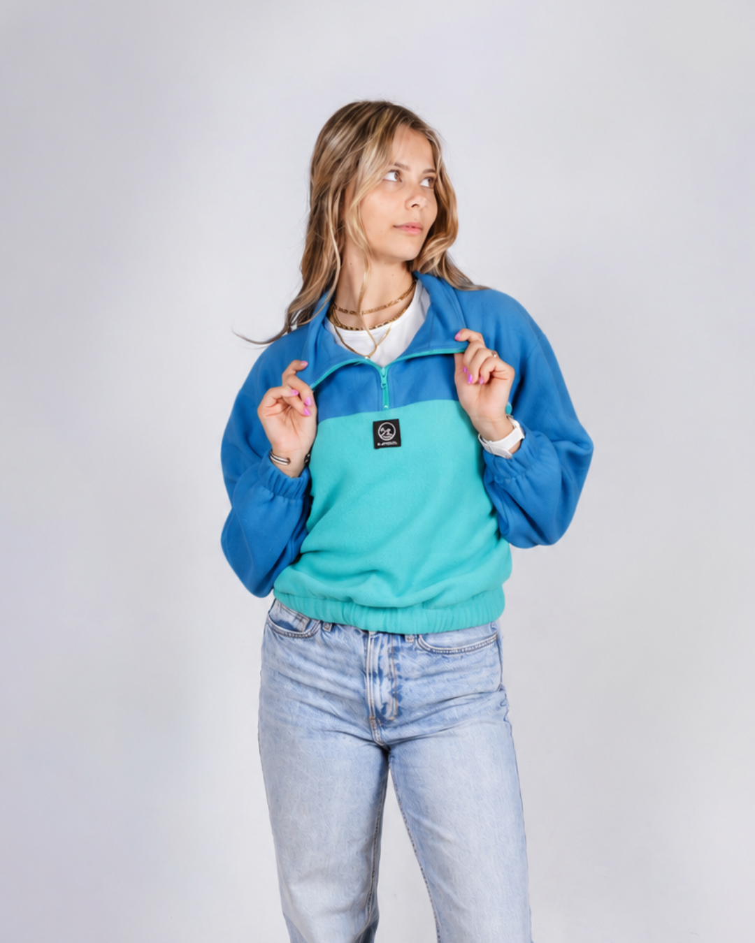 Female wearing a teal / blue retro jersey in studio