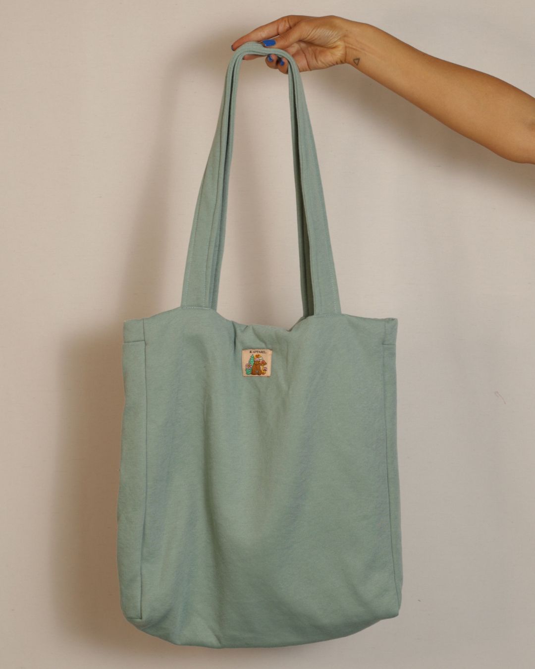 Teal tote bag with a patch 