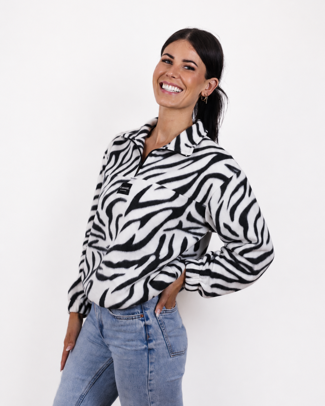 Female wearing the Zebra quarter zip jersey in studio