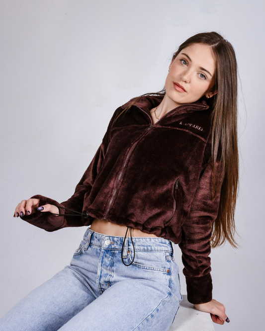 woman wearing a brown fluffy jacket with draw cords and thumb holes 