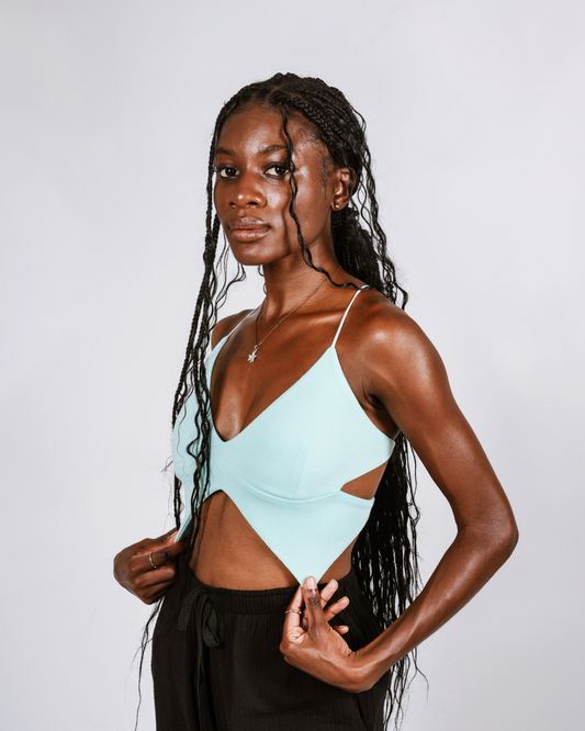 Woman wearing a teal butterfly shaped top that ties at the back