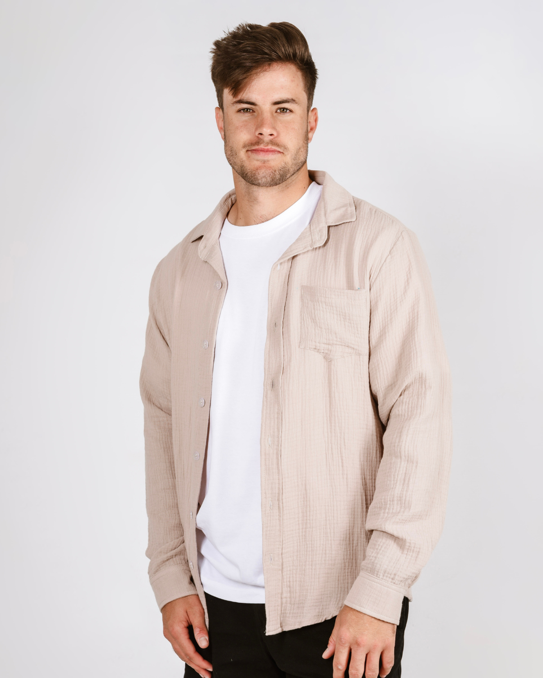 Male wearing a cream cotton button up shirt 
