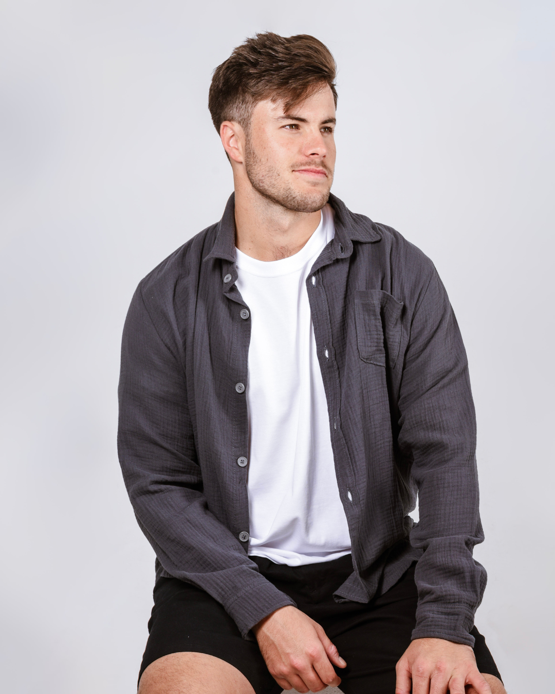 male in a grey cotton button up shirt 