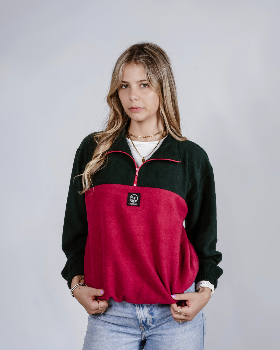 female wearing a maroon and green quarter zip  fleece jersey 