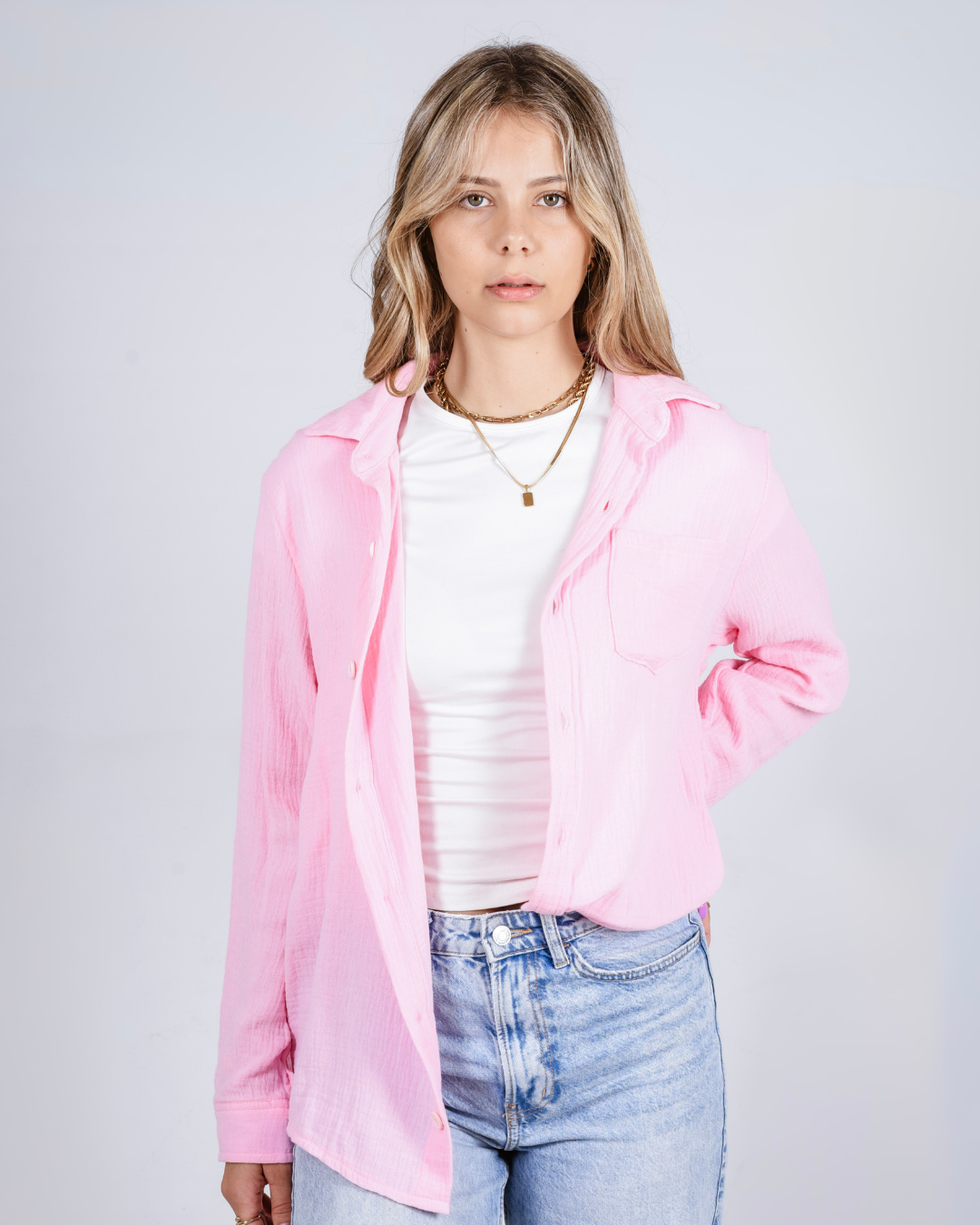 female wearing a Pink button up cotton shirt 
